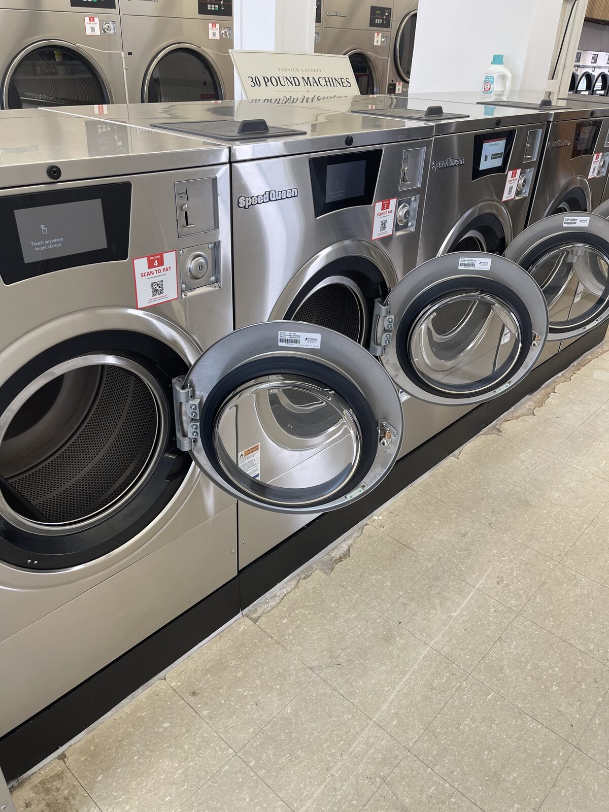 Row of Speed Queen 30 lb front-load washers at Parvich Laundry